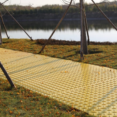 Lawn protection mats preventing damage to grass and turf from vehicle traffic.