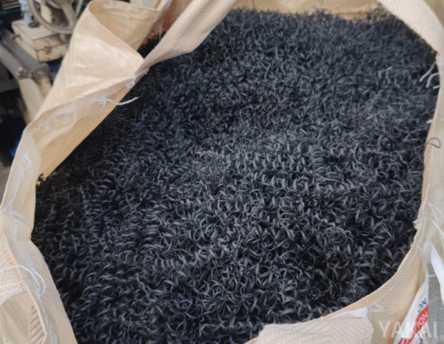 Black plastic scraps collected for recycling into recycled plastic sheets