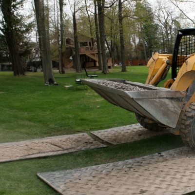 Skid Steer Mats stabilize access on unstable surfaces, preventing equipment damage and slipping.