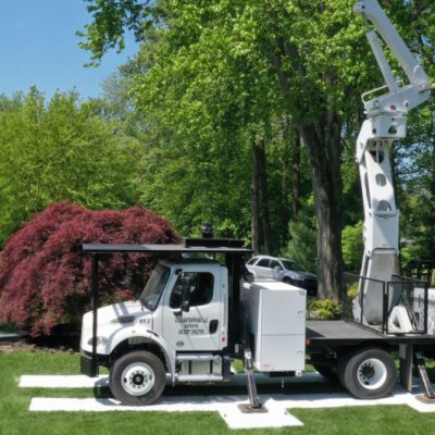 Composite landscaping mats protecting turf during landscaping work.